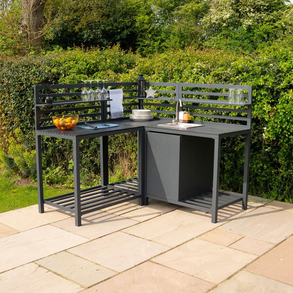 Stylish aluminium outdoor kitchen set featuring a sleek black finish, open shelving, and space for plates and glasses, perfect for entertaining