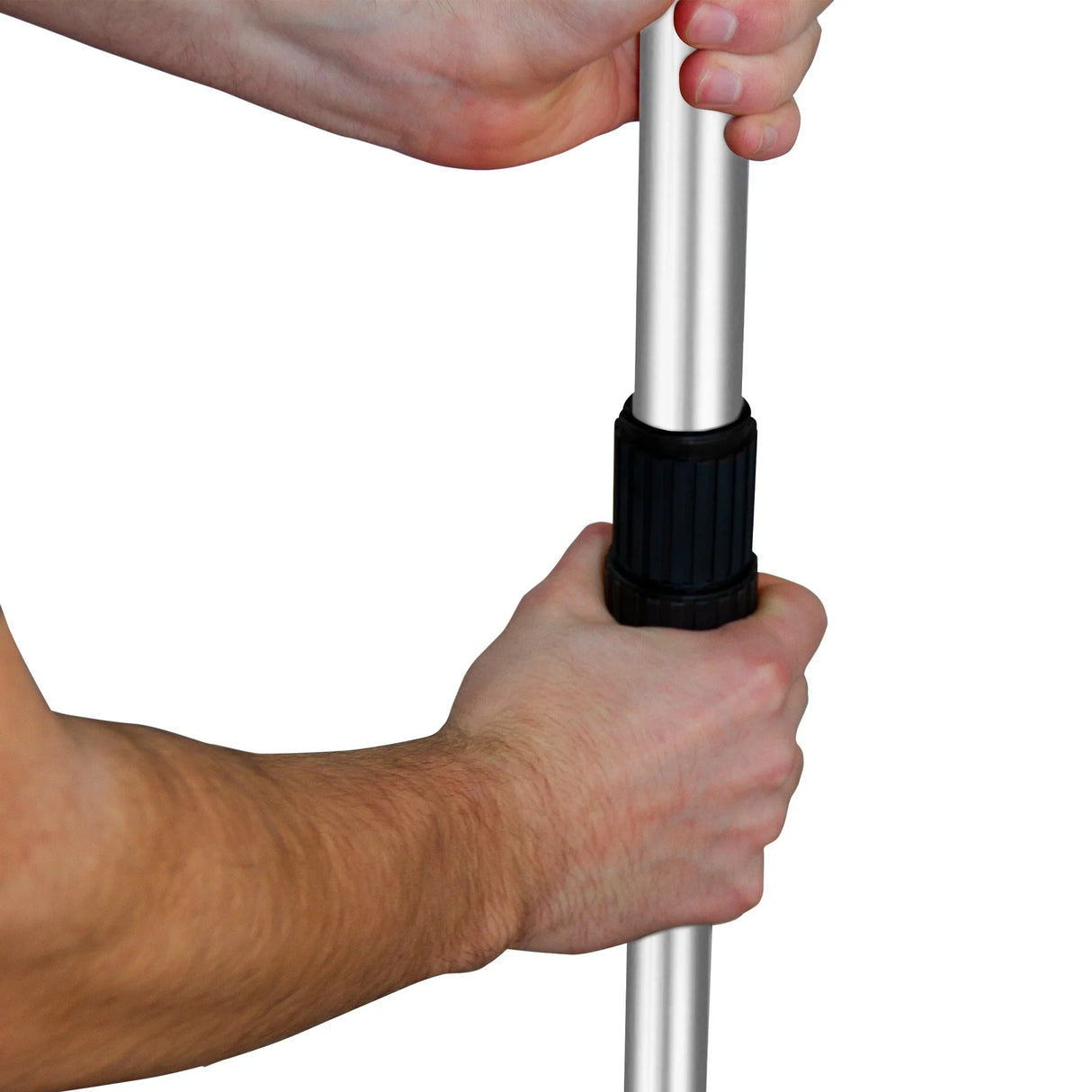 Close-up of a hand gripping the adjustable handle of a rotary spreader, showcasing the sturdy black grip and silver pole design