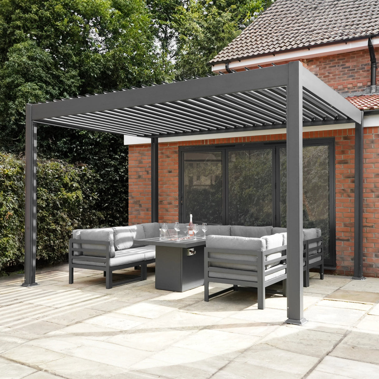 Anthracite aluminum pergola with LED lights, featuring a sleek design and spacious seating area, perfect for outdoor gatherings