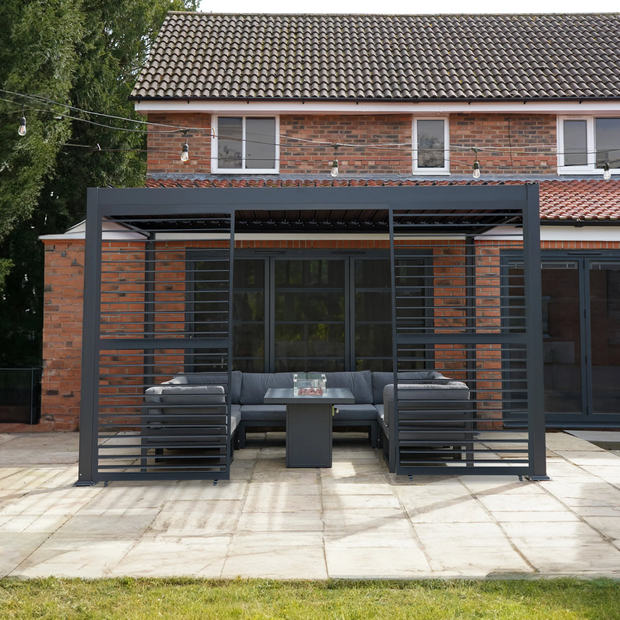 Anthracite aluminum pergola with two shutter panels, featuring a modern design, sleek lines, and a spacious outdoor seating area