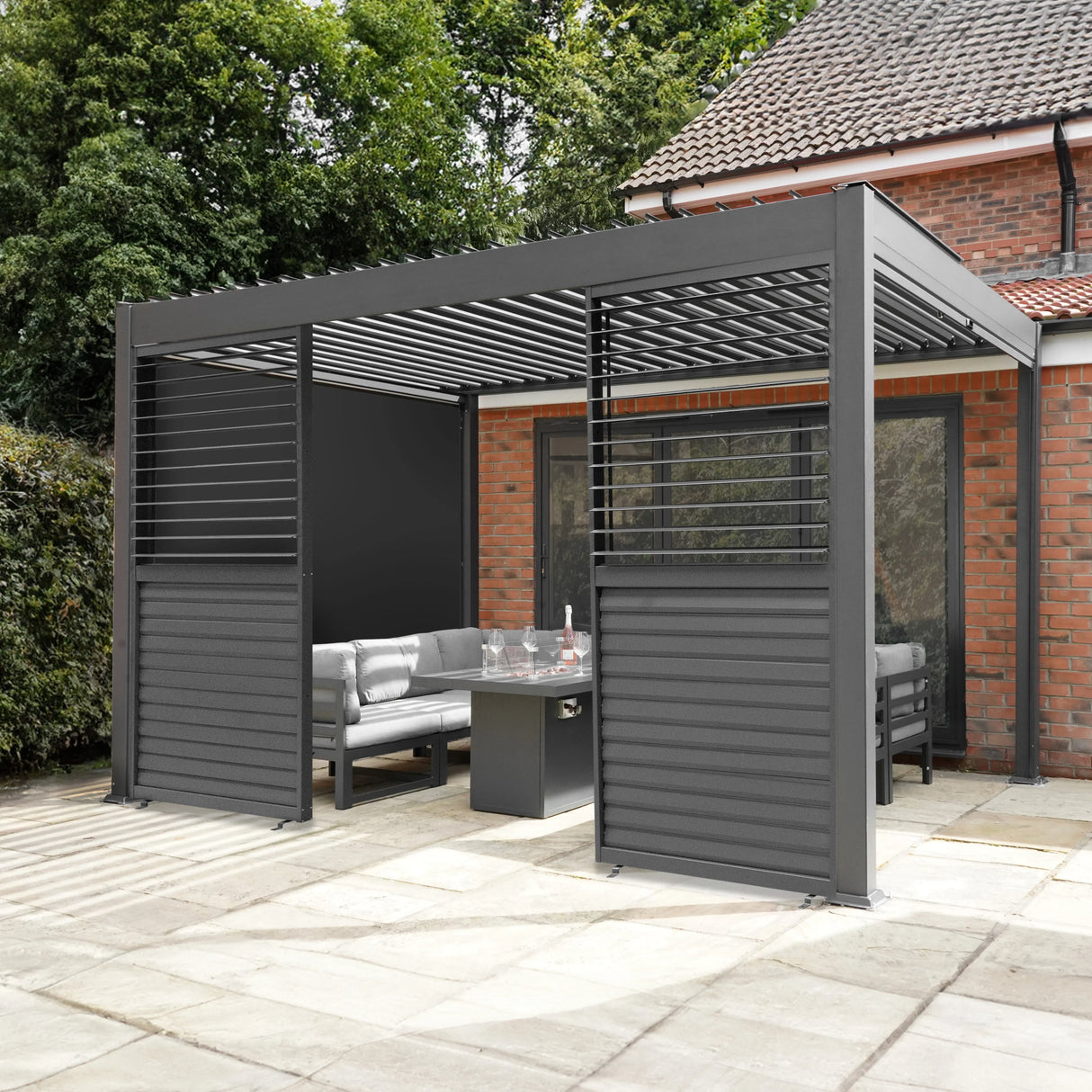 Aluminium pergola with anthracite blinds, two side panels, and integrated LED lights, providing a stylish outdoor seating area