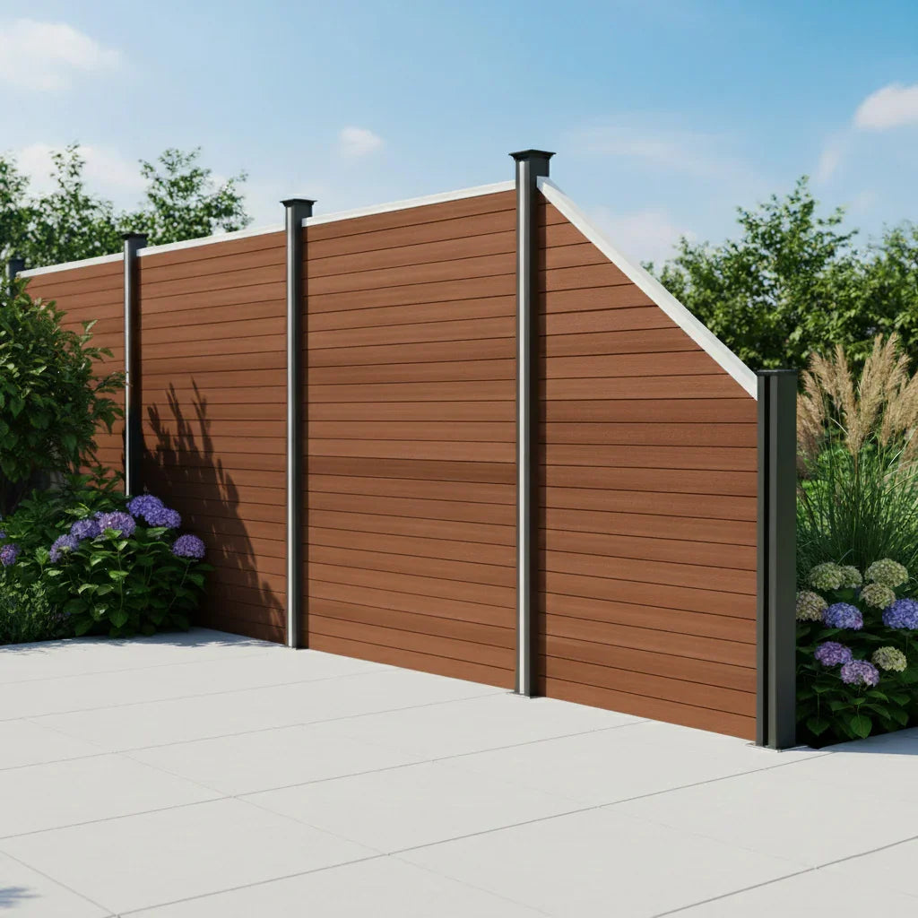 Composite angled fence panel in rich brown color with sleek black posts, surrounded by lush greenery and colorful flowers