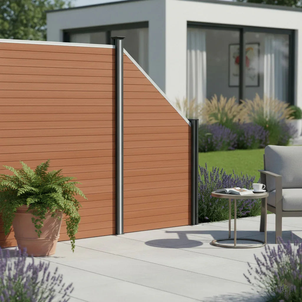 Composite angled fence panel in rich brown, featuring a textured finish and sleek black posts, set in a modern outdoor space with greenery and patio furniture