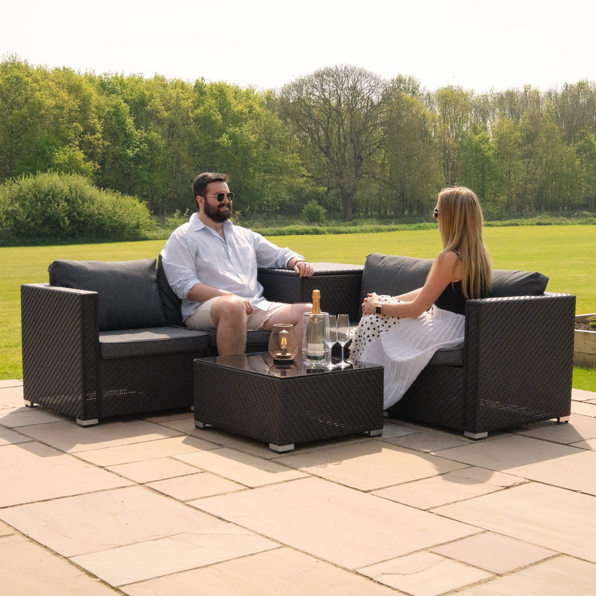 Rattan modular 6-piece furniture set in black with plush gray cushions, featuring a coffee table, perfect for outdoor lounging