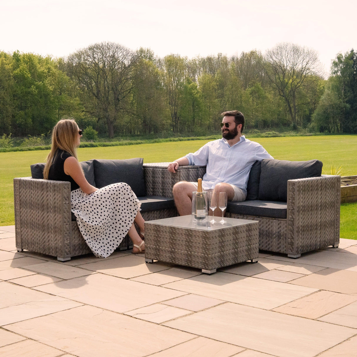 Grey rattan modular 6-piece furniture set with plush cushions, featuring a coffee table, ideal for outdoor lounging and gatherings