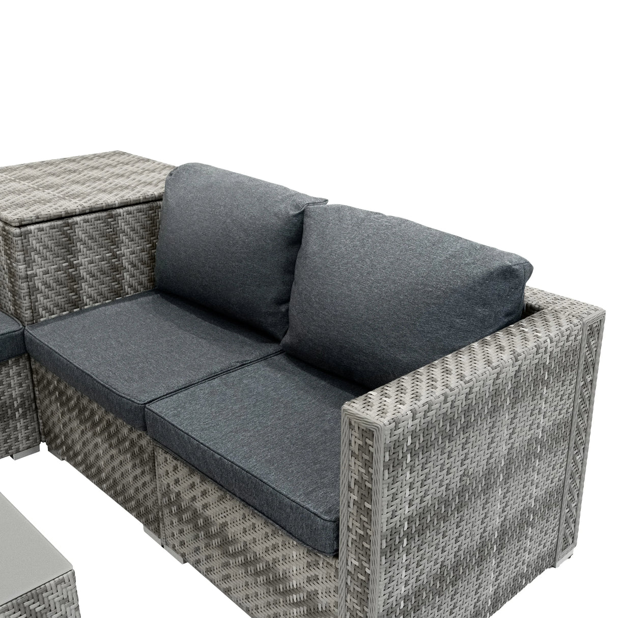 Grey rattan modular furniture set with plush cushions, featuring a contemporary design and woven texture, ideal for outdoor spaces