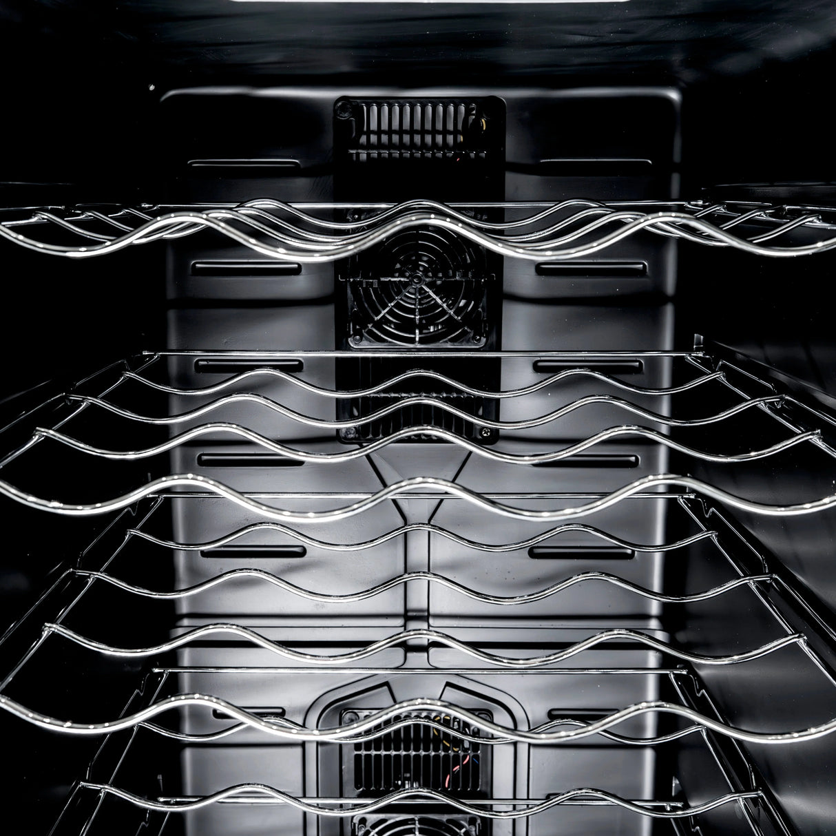 Interior view of the Oriva LED Wine Cooler showcasing sleek chrome racks, black finish, and efficient cooling fan for optimal wine storage