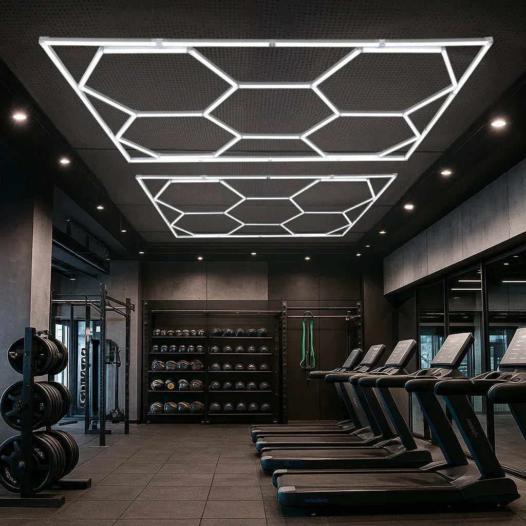 Hexagon LED lighting panels illuminate a modern gym, featuring sleek white geometric designs against a dark ceiling