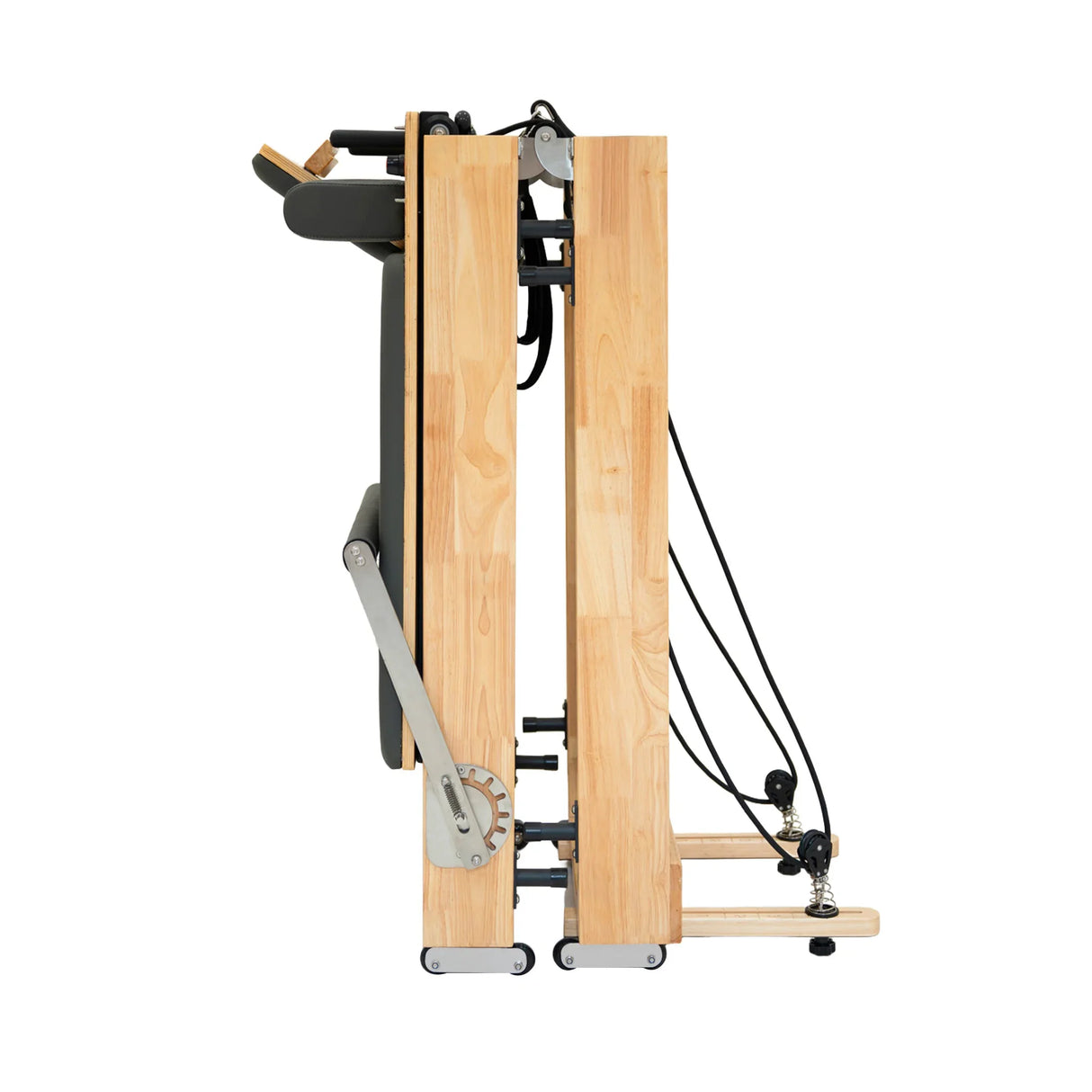 Pilates reformer machine in oak wood, featuring a sleek, compact design with adjustable resistance cords and padded platform
