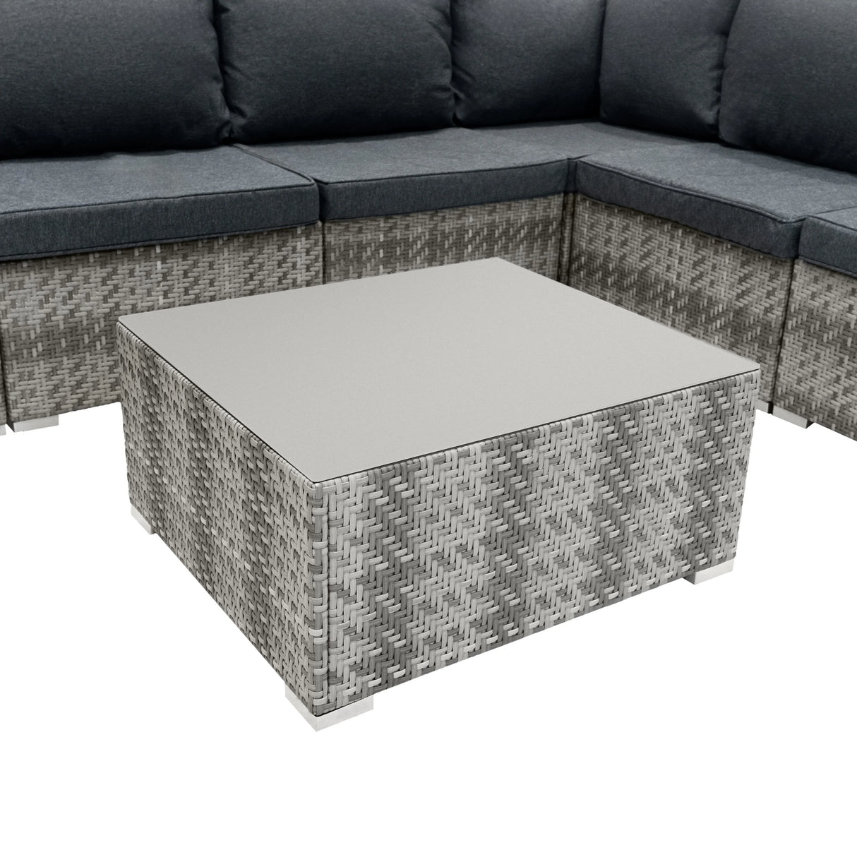 Grey rattan modular furniture set with plush cushions and a sleek, square coffee table featuring a smooth glass top