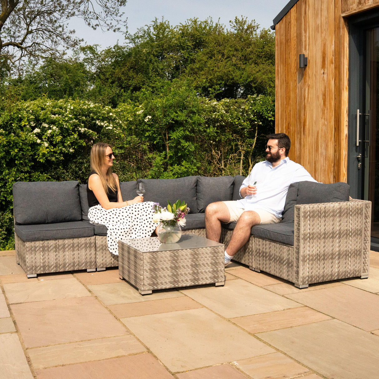 Rattan modular 7-piece furniture set in grey with plush cushions, featuring a coffee table, perfect for outdoor relaxation