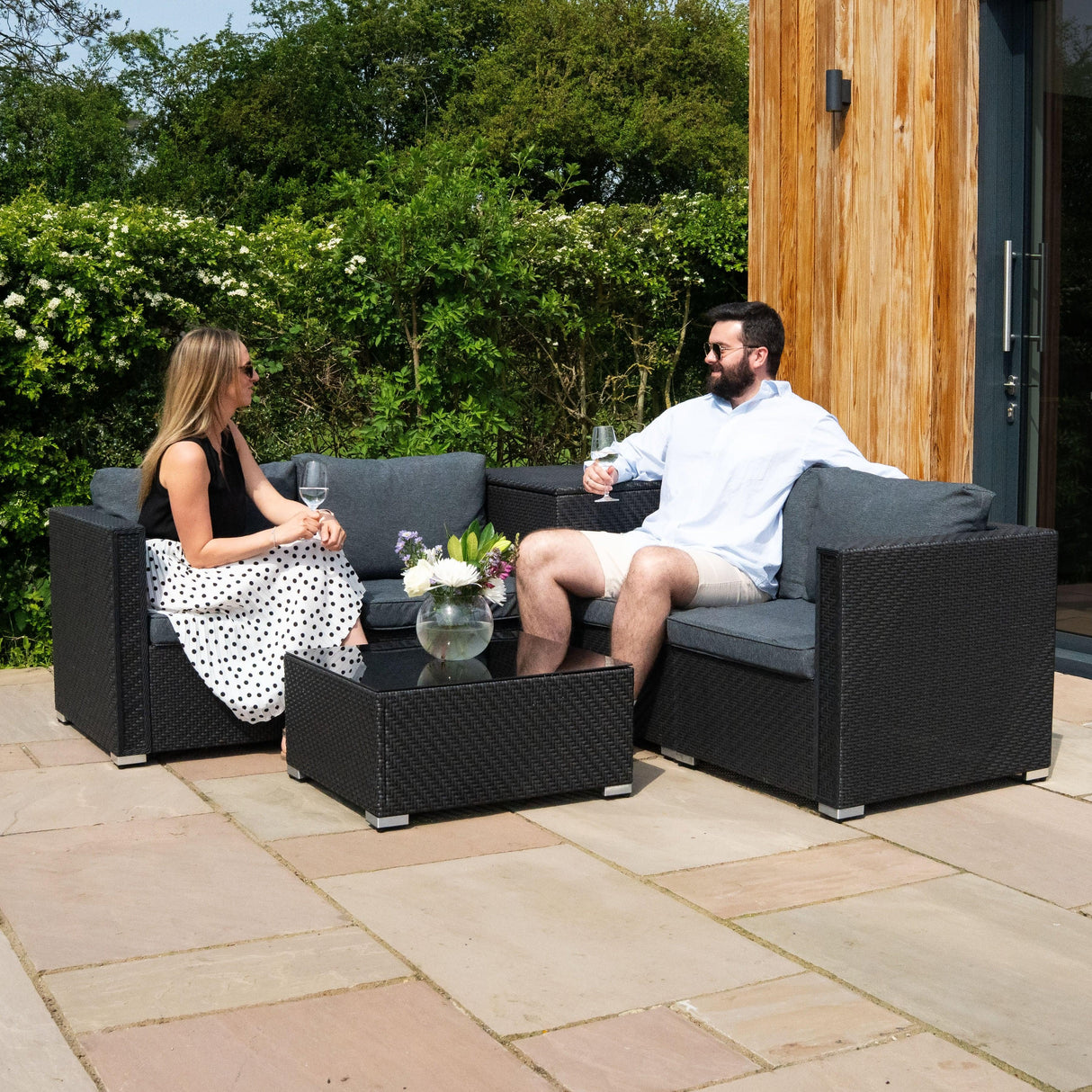 Rattan modular 6-piece furniture set in black with gray cushions, featuring a coffee table, perfect for outdoor relaxation and entertaining