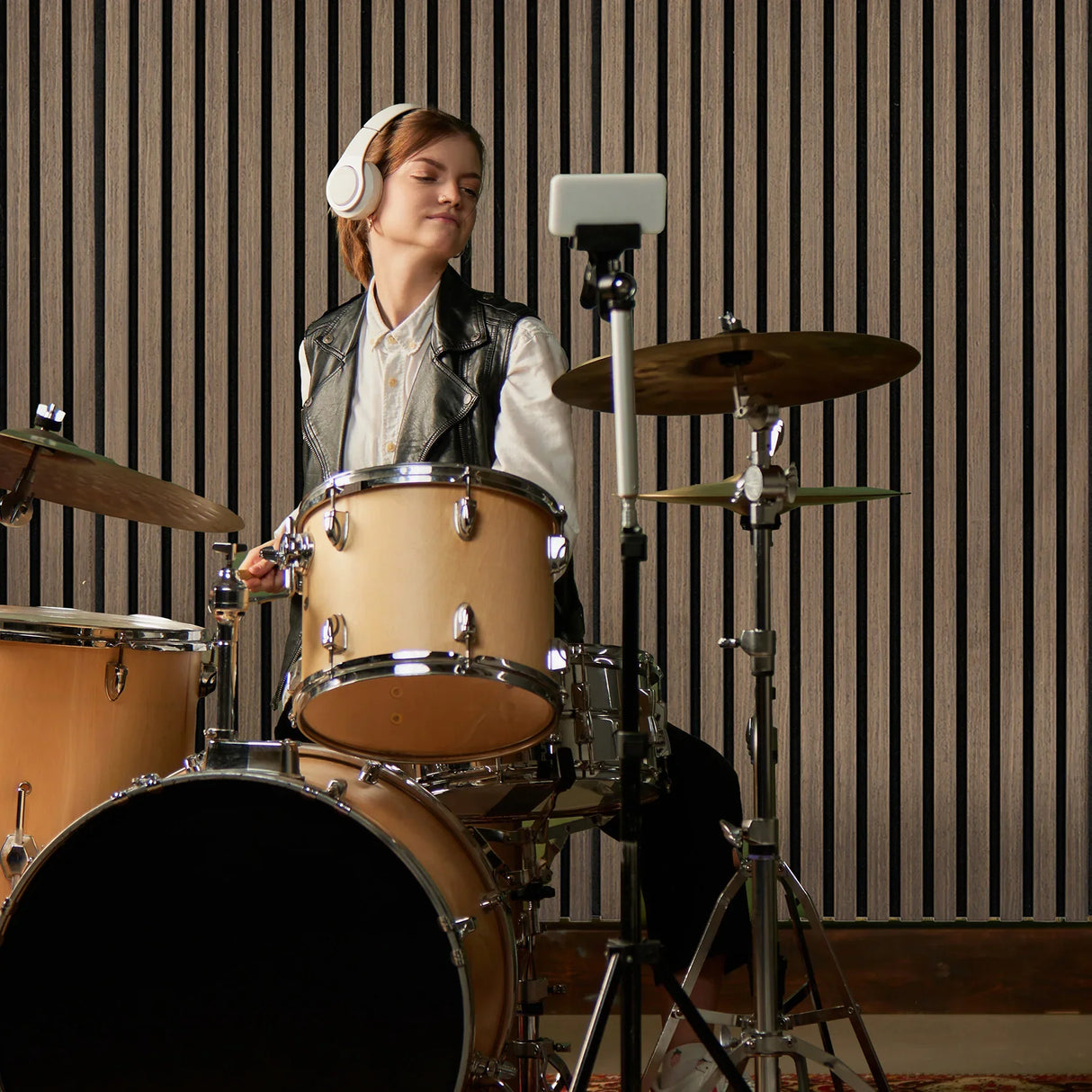 Acoustic slat wall panels in dark walnut enhance sound quality, featuring a sleek, textured finish, perfect for music studios