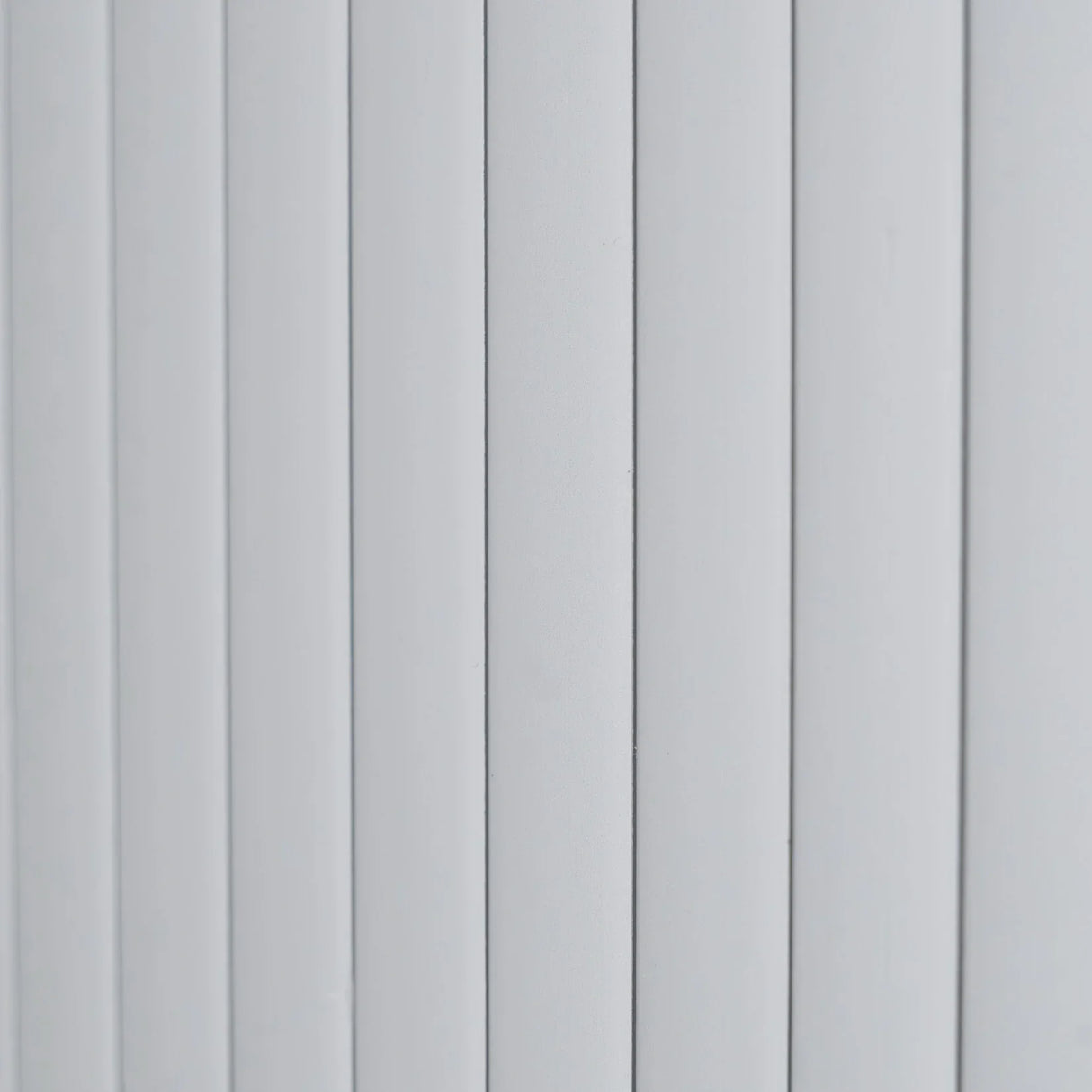 Silver Tambour shower door featuring a sleek, vertical slat design with a smooth, modern finish, ideal for contemporary bathrooms