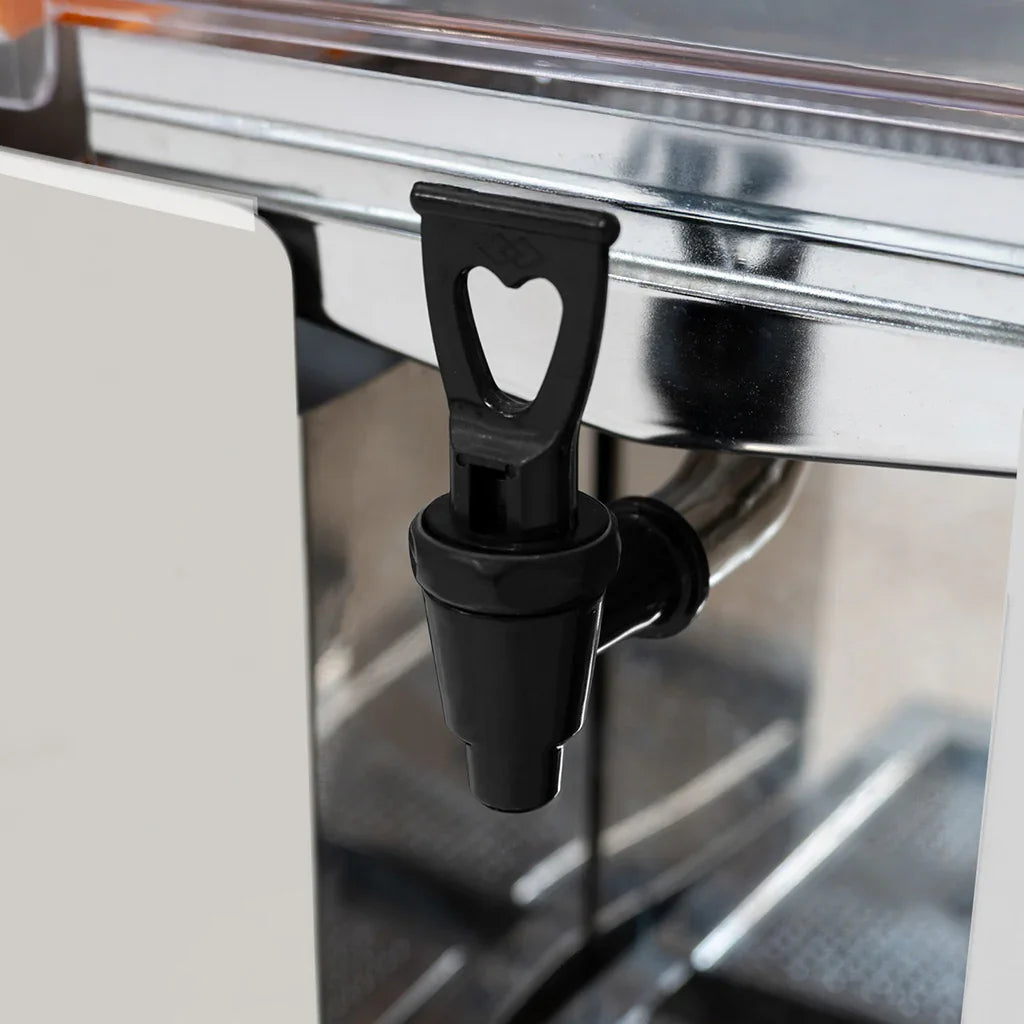 Commercial fruit juicer spout in black plastic, featuring a heart-shaped handle, set against a sleek stainless steel body