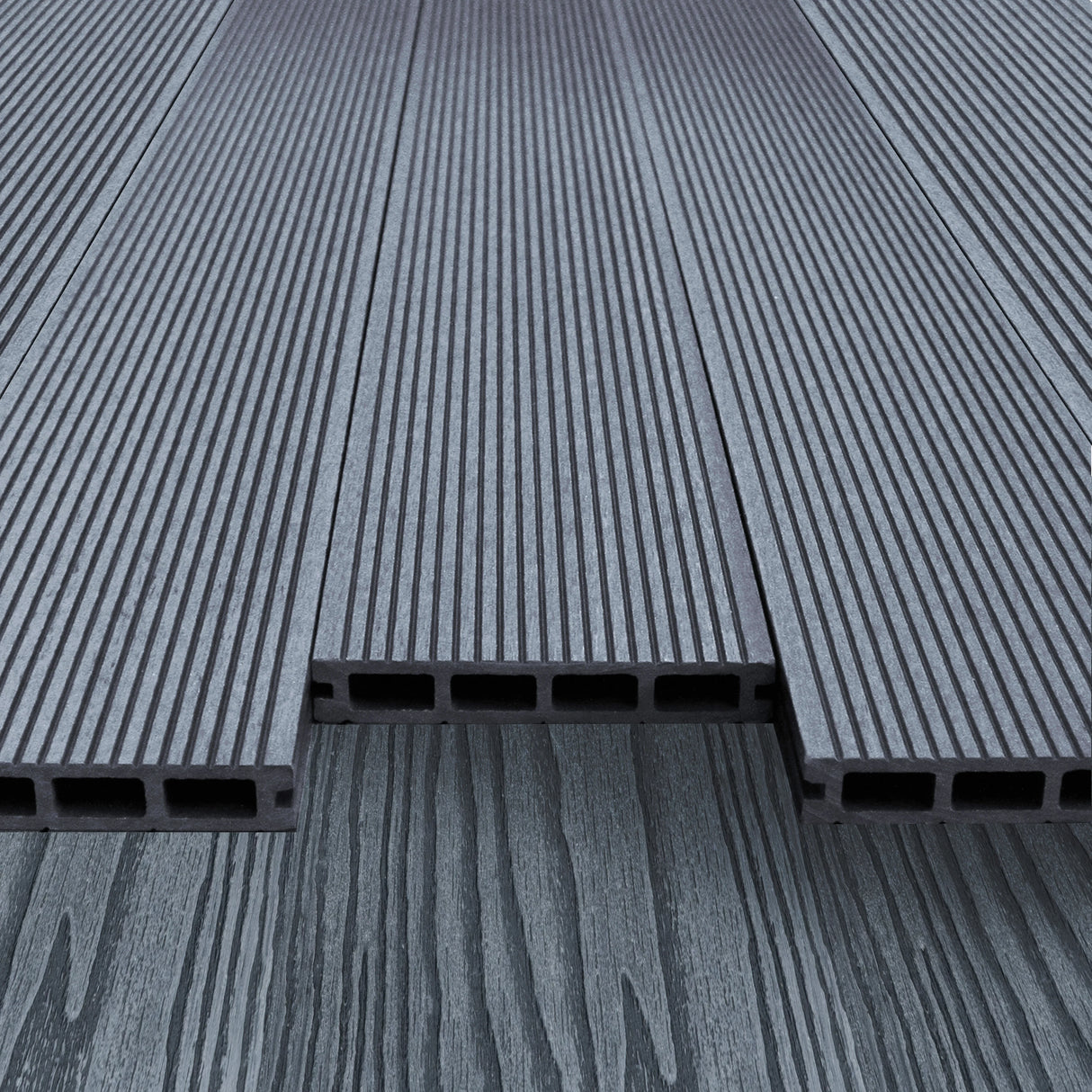 Grey composite decking boards with a textured surface and hollow design, showcasing durability and modern aesthetics for outdoor spaces