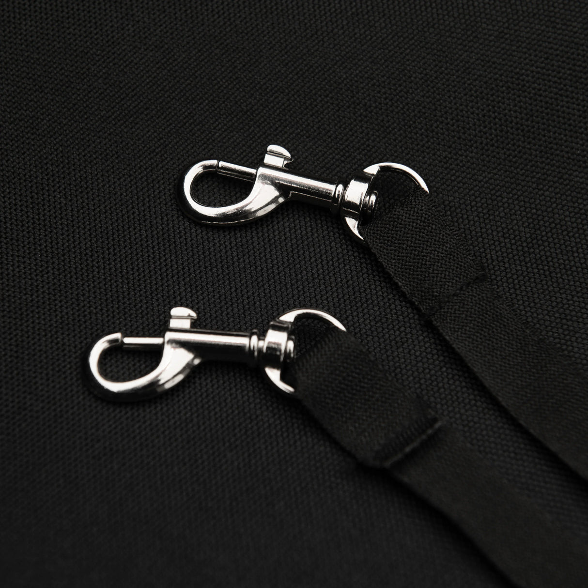 Durable metal clips on black straps for secure attachment to the Pet Jogger, designed for safety and convenience during walks