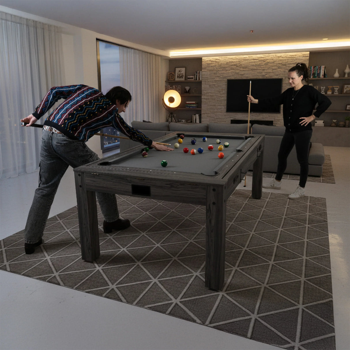 7-In-1 Games Table in grey with a textured surface, featuring players enjoying billiards in a modern living room setting