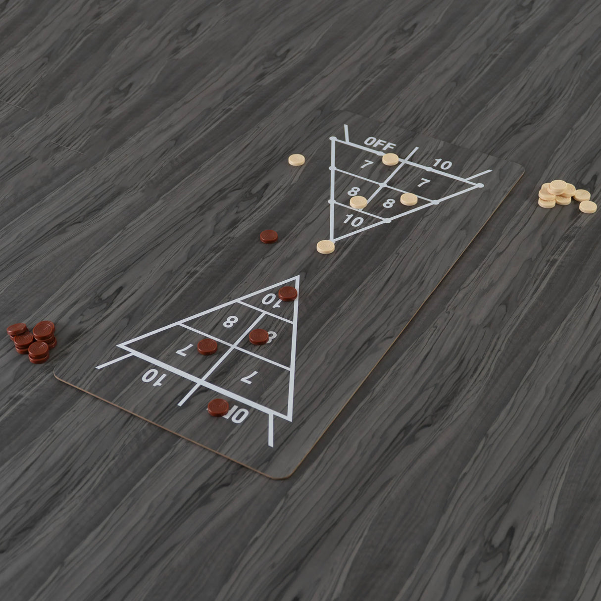 Grey 7-in-1 games table with a smooth surface, featuring a shuffleboard design and colorful game pieces scattered around