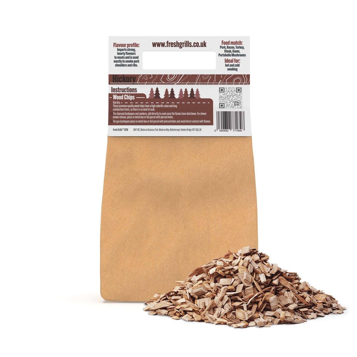 Hickory BBQ smoking wood chips in a brown paper bag, with a pile of finely shredded wood chunks for grilling and smoking flavor