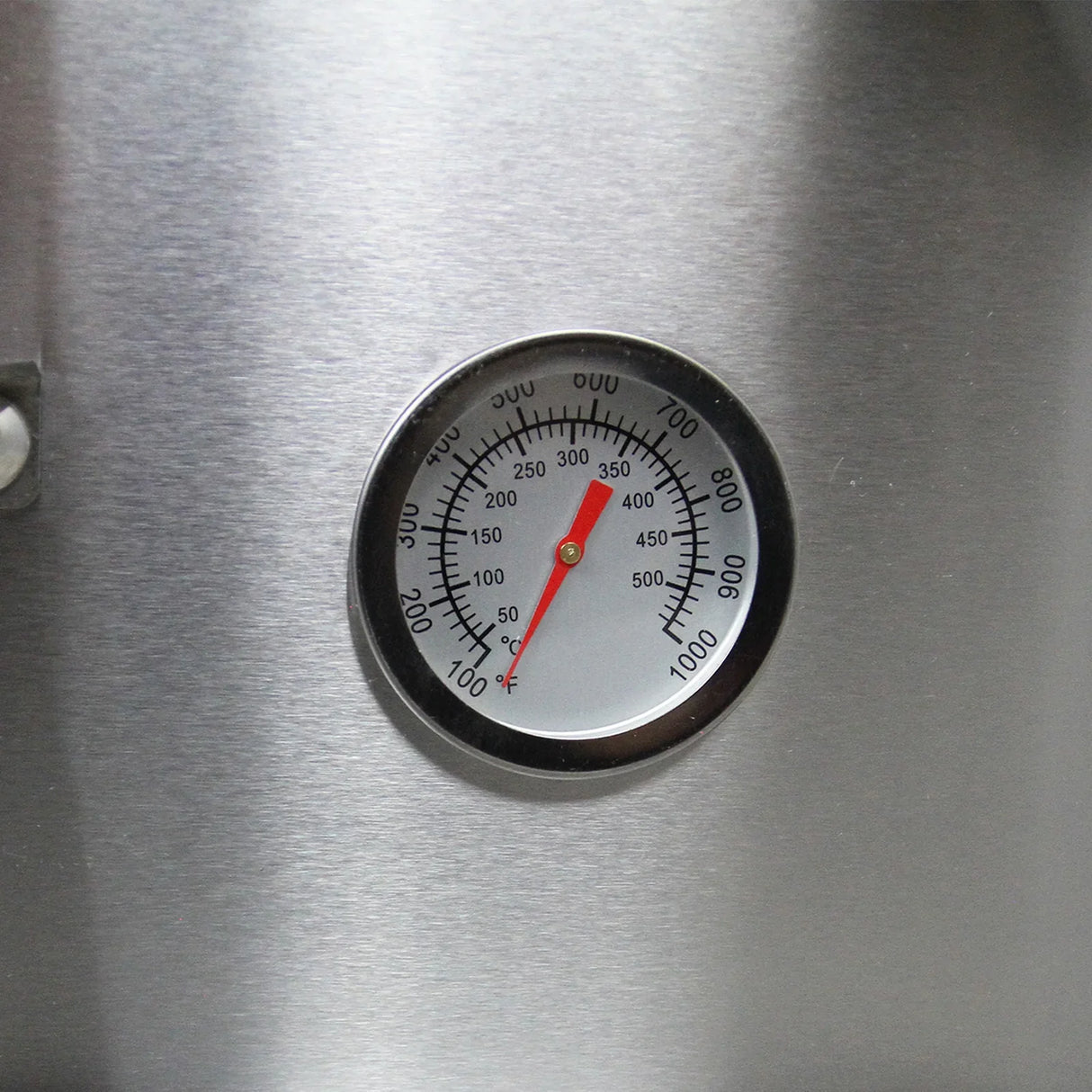 Thermometer gauge displaying temperature settings on the stainless steel surface of the anthracite grey table top pizza oven