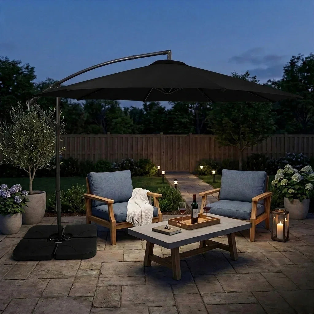 Stylish black cantilever parasol with a 3m canopy, providing shade over a modern outdoor seating area with wooden chairs and a stone table