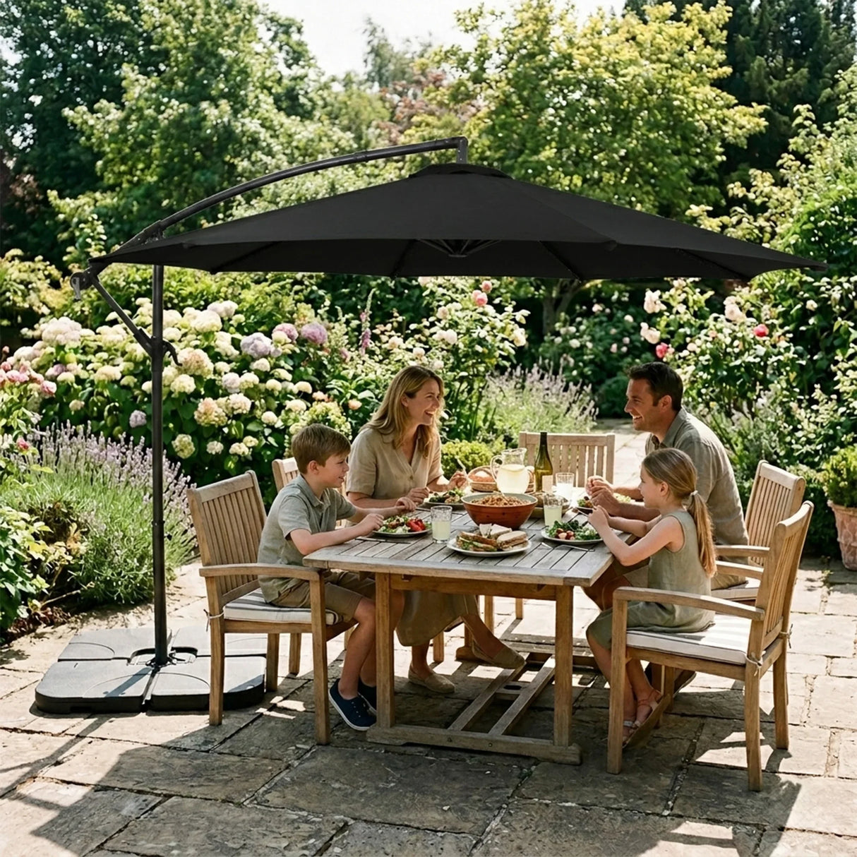 Stylish 3m cantilever parasol in black, providing shade over a wooden dining table with a family enjoying a meal in a garden setting