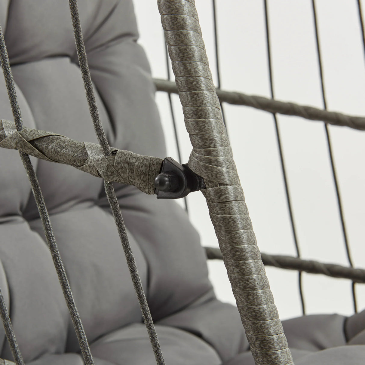 Grey rattan hanging egg chair featuring a cushioned seat, woven texture, and sturdy frame, ideal for indoor or outdoor relaxation