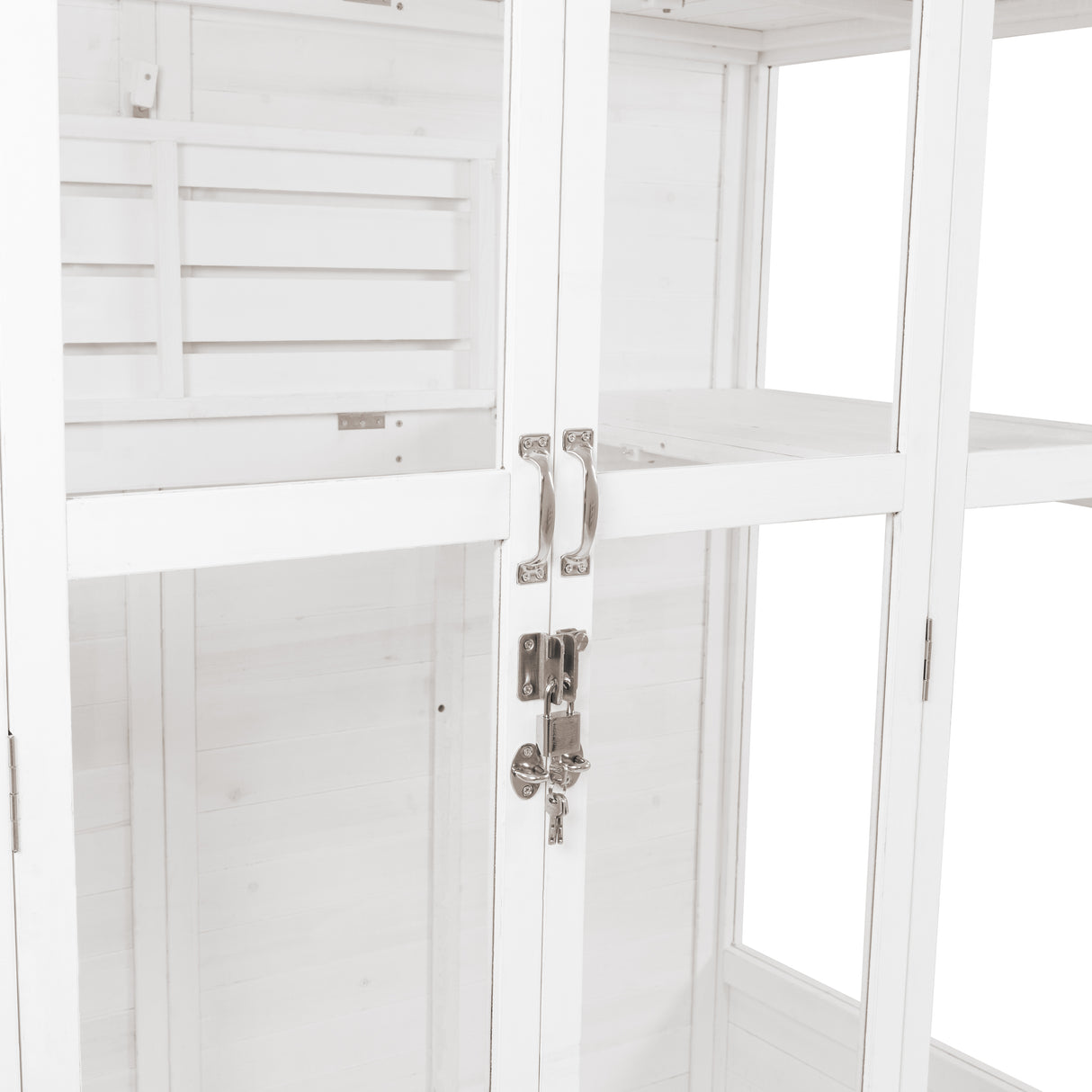 Elegant Victorian greenhouse in white wood, featuring glass panels, silver handles, and a secure lock for plant protection