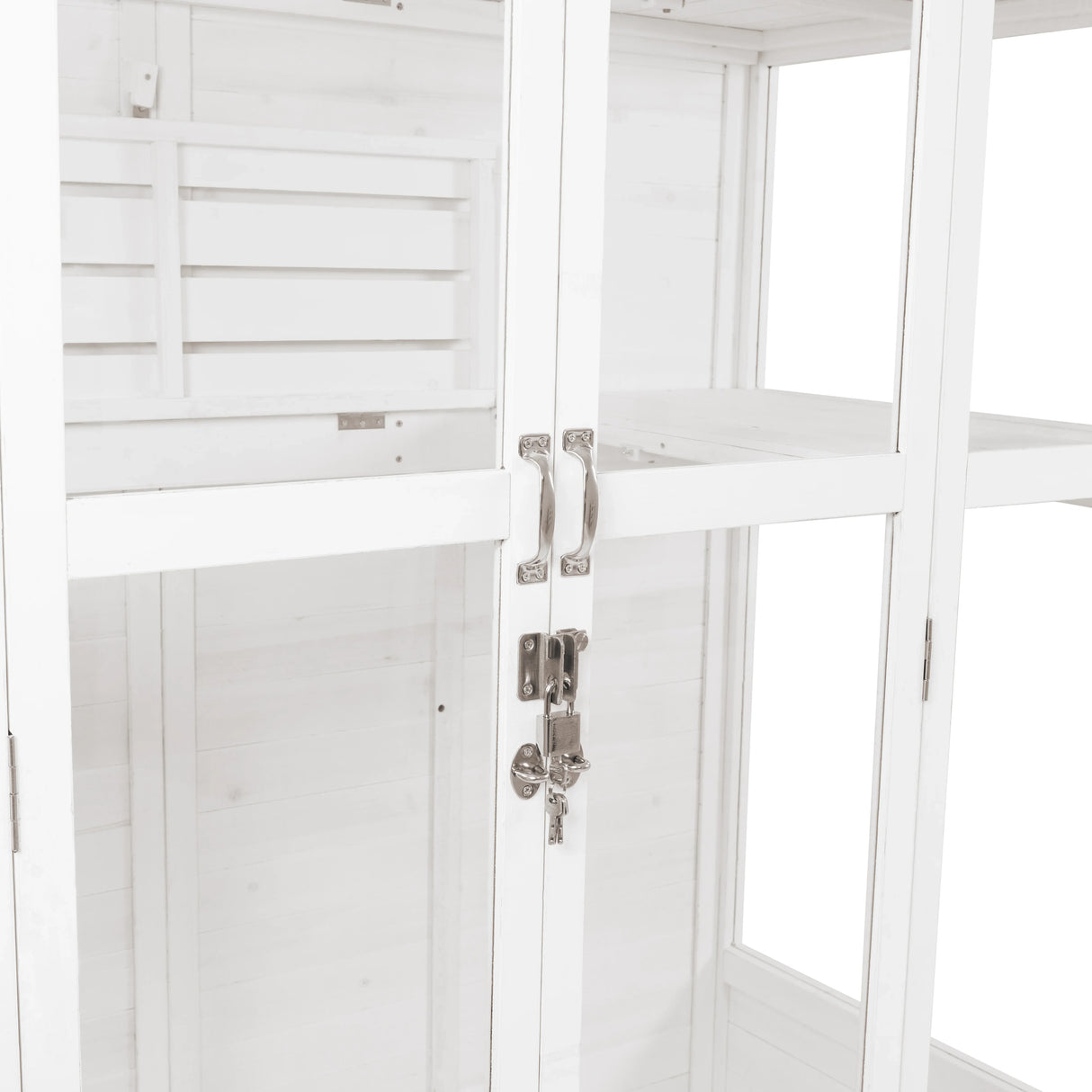 Elegant Victorian greenhouse in white wood, featuring glass panels, silver handles, and a secure lock for plant protection