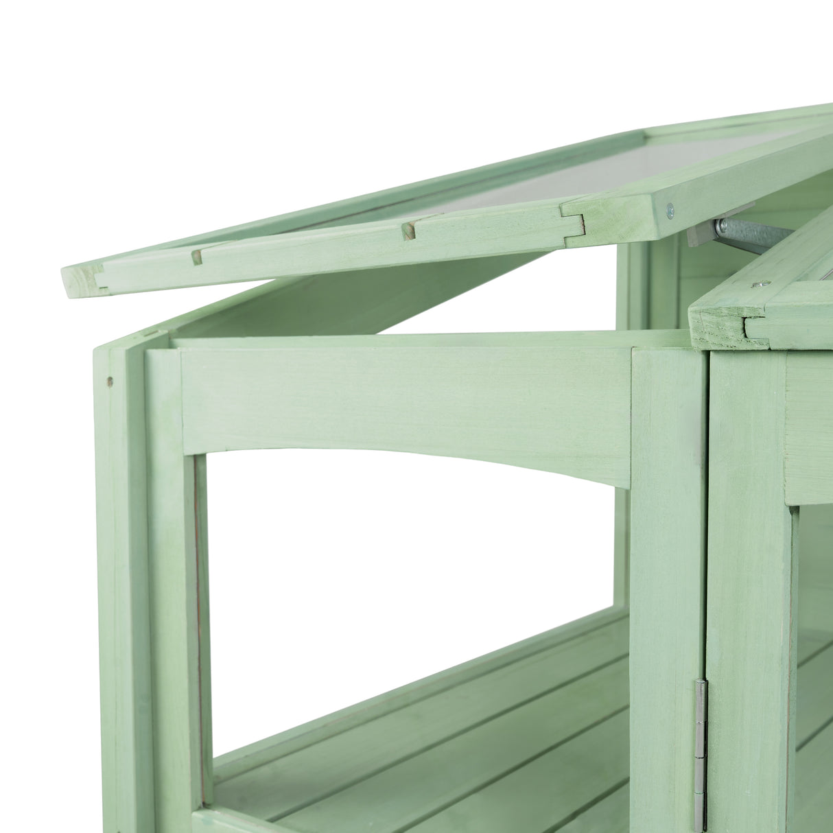 Victorian greenhouse in soft green wood, featuring slatted shelves and a sloped roof, perfect for nurturing plants indoors or outdoors