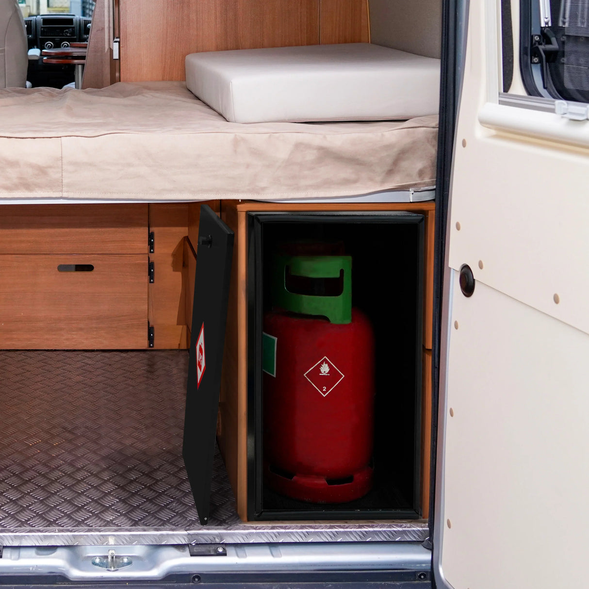 Compact black gas bottle locker securely holds a 6kg red gas bottle, designed for van interiors with wooden finishes and a textured floor
