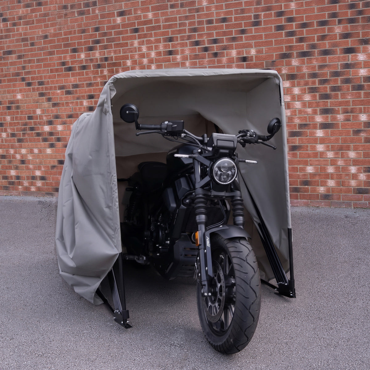 Grey medium motorbike tent featuring a durable fabric cover, protecting a sleek black motorcycle from the elements against a brick wall
