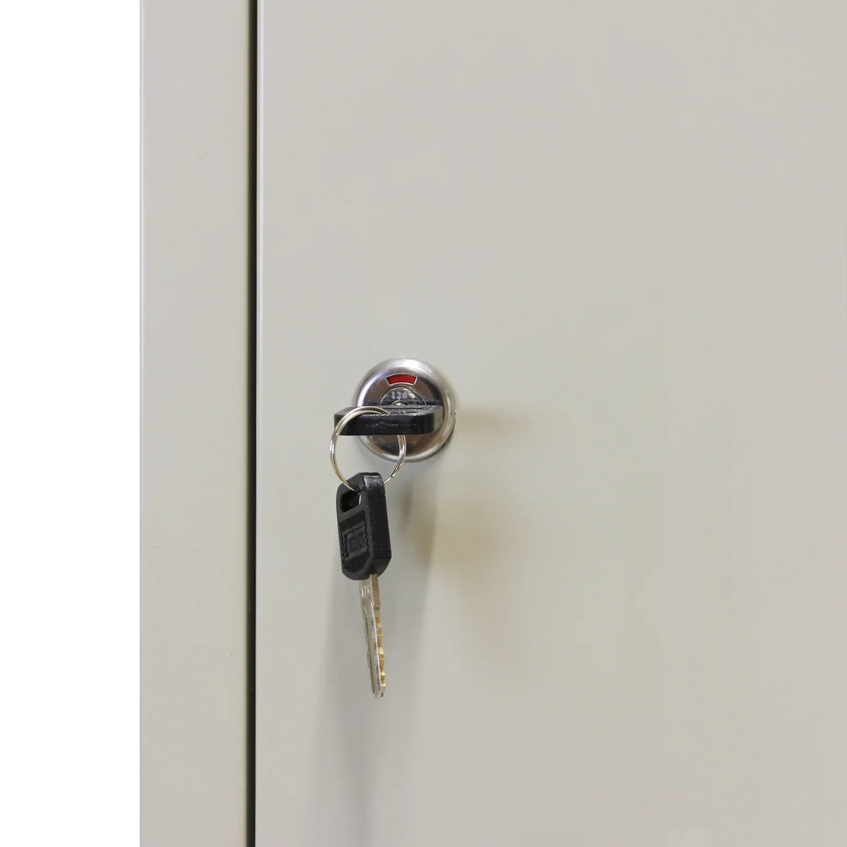 Grey metal storage locker with three doors, featuring a shiny keyhole and key, showcasing a sleek and durable design