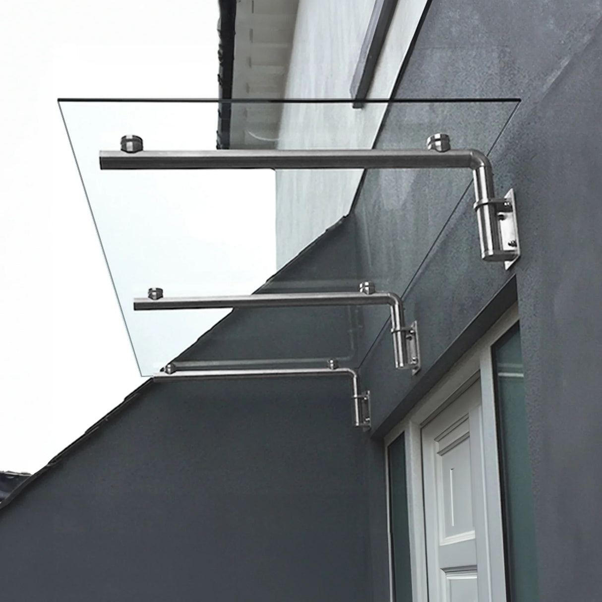 Clear glass door canopy with sleek stainless steel brackets, measuring 180cm wide by 80cm deep, mounted above a white door