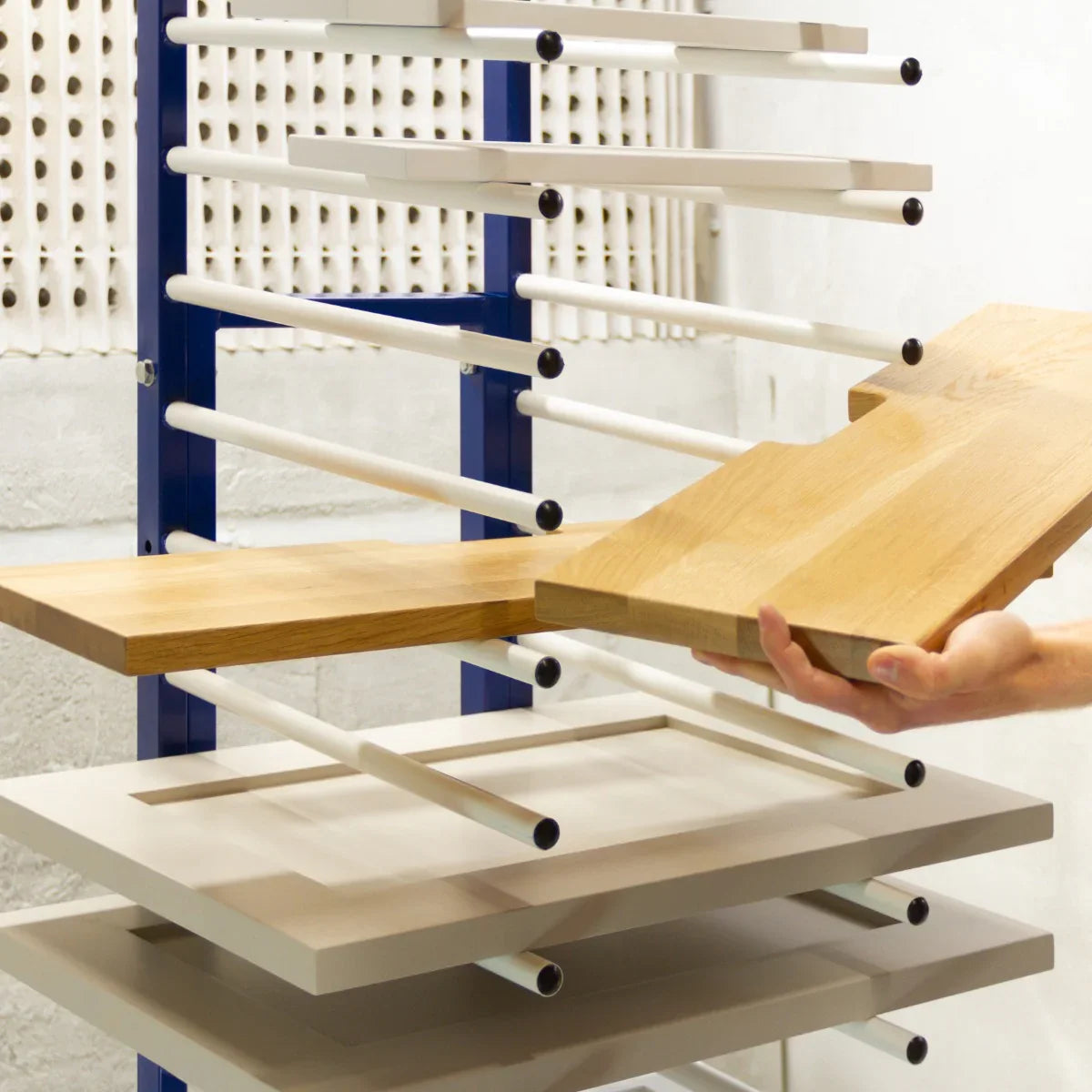 Monster Racking Spray Drying Rack Trolley with multiple shelves, featuring a mix of wood and white surfaces, ideal for drying materials