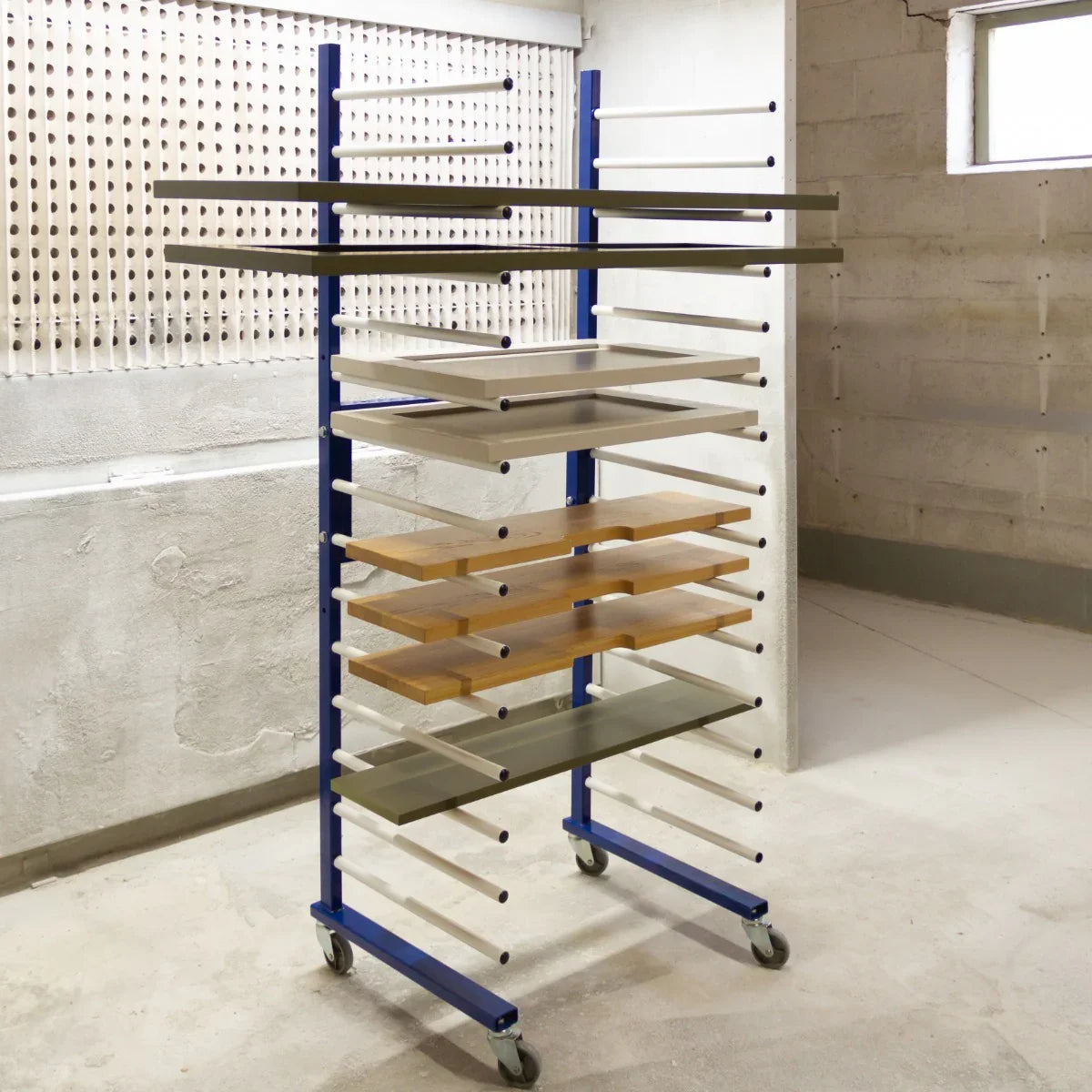 Monster Racking Spray Drying Rack Trolley with multiple shelves in blue and wood finish, designed for efficient drying and storage