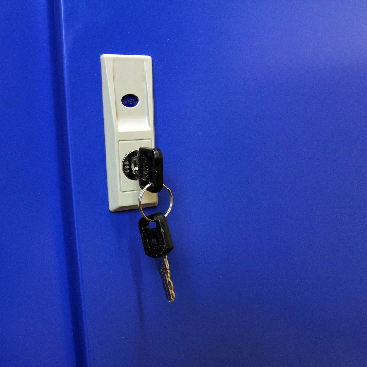 Close-up of a blue cigarette and vape display cabinet lock with keys inserted, showcasing security features and sleek design