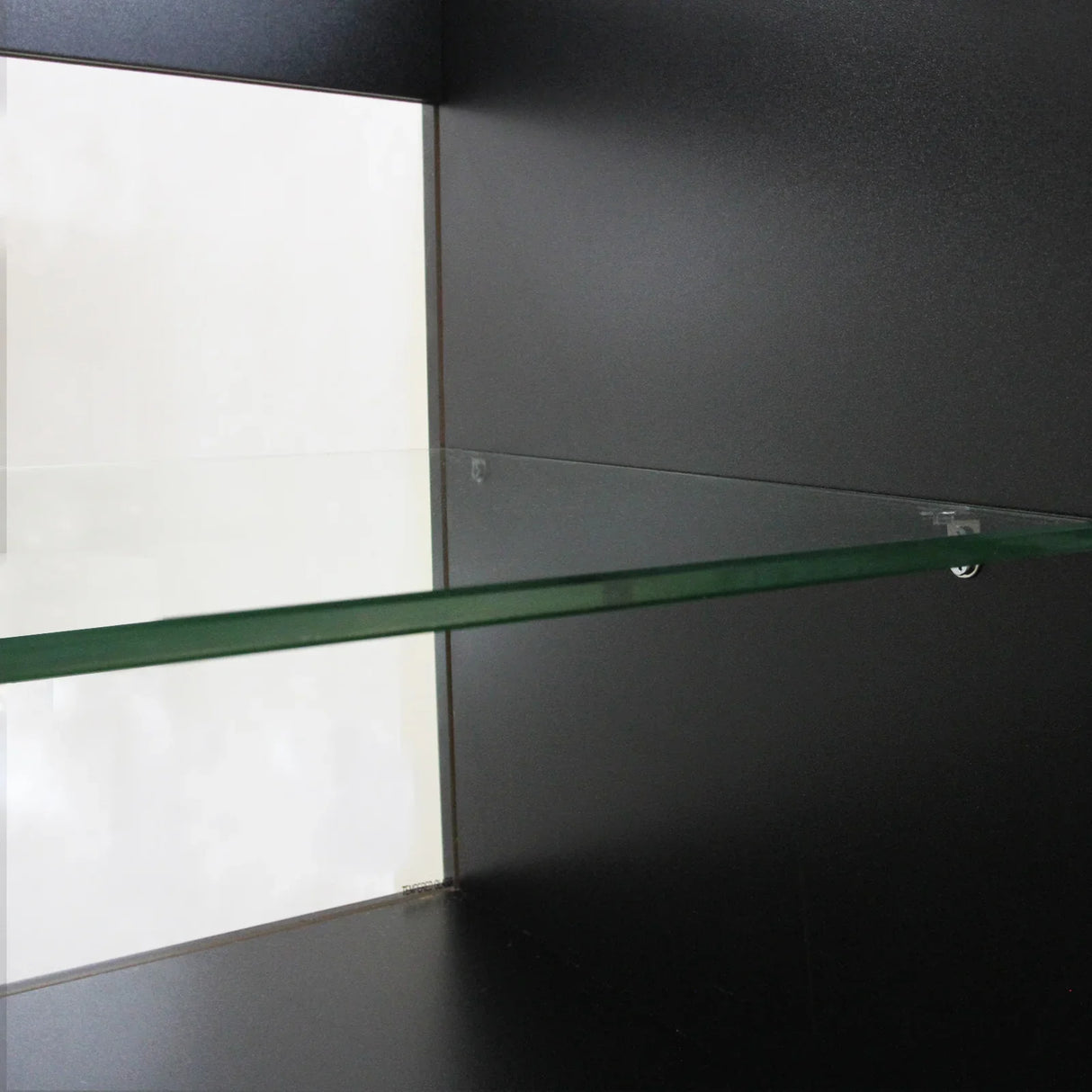Black C1200 shop counter featuring a sleek glass shelf, showcasing a modern design with smooth surfaces and sharp edges