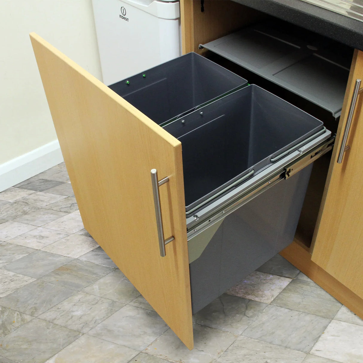 KuKoo 90L pull-out recycle waste bin with two gray containers, sleek metal handles, and a wooden cabinet door for easy access