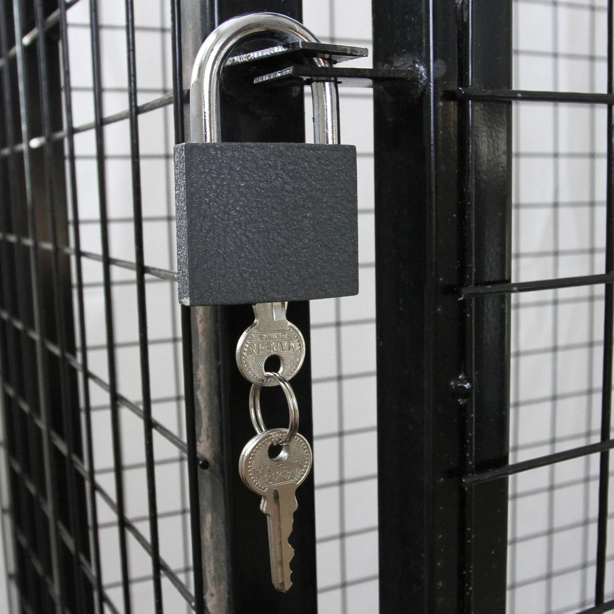 Close-up of a black padlock securing a gas bottle mesh cage, featuring a sturdy metal frame and grid design for safety and durability