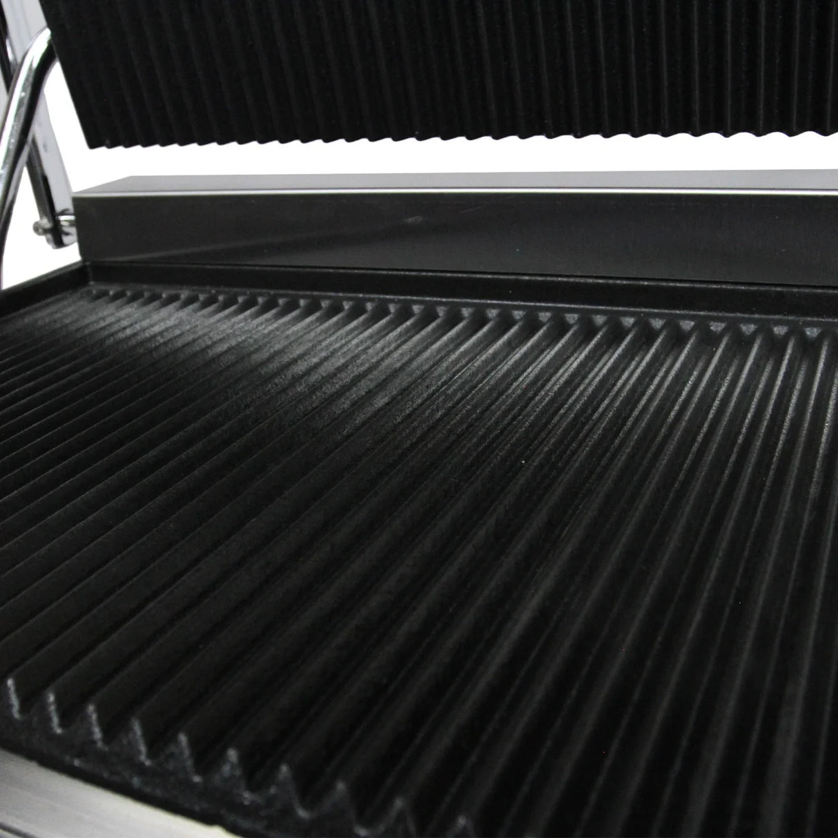Grooved cooking surface of the KuKoo Panini Press, featuring a sleek black non-stick finish and durable stainless steel frame