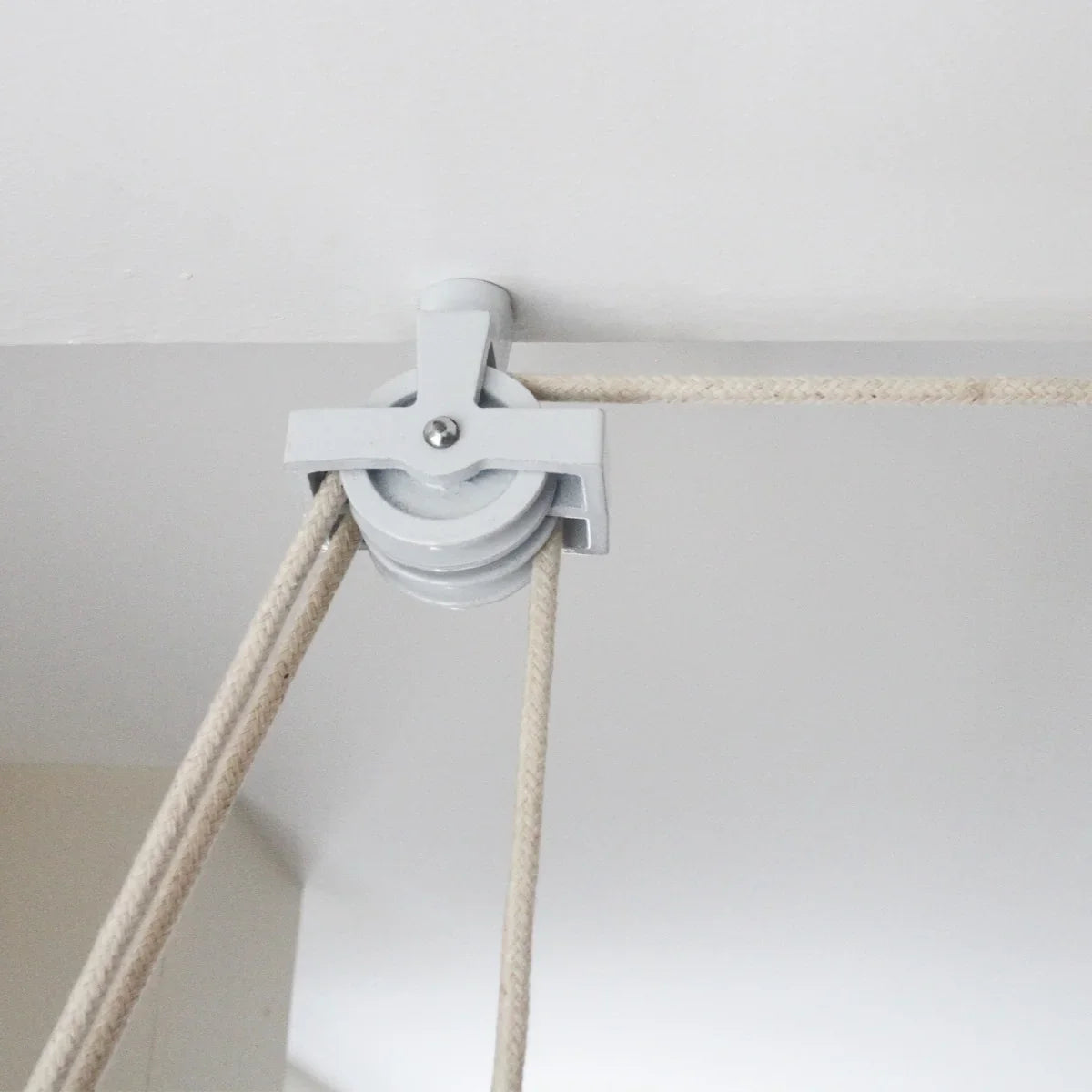 Ceiling pulley clothing airer in white, featuring durable ropes and a sleek design for efficient laundry drying in small spaces