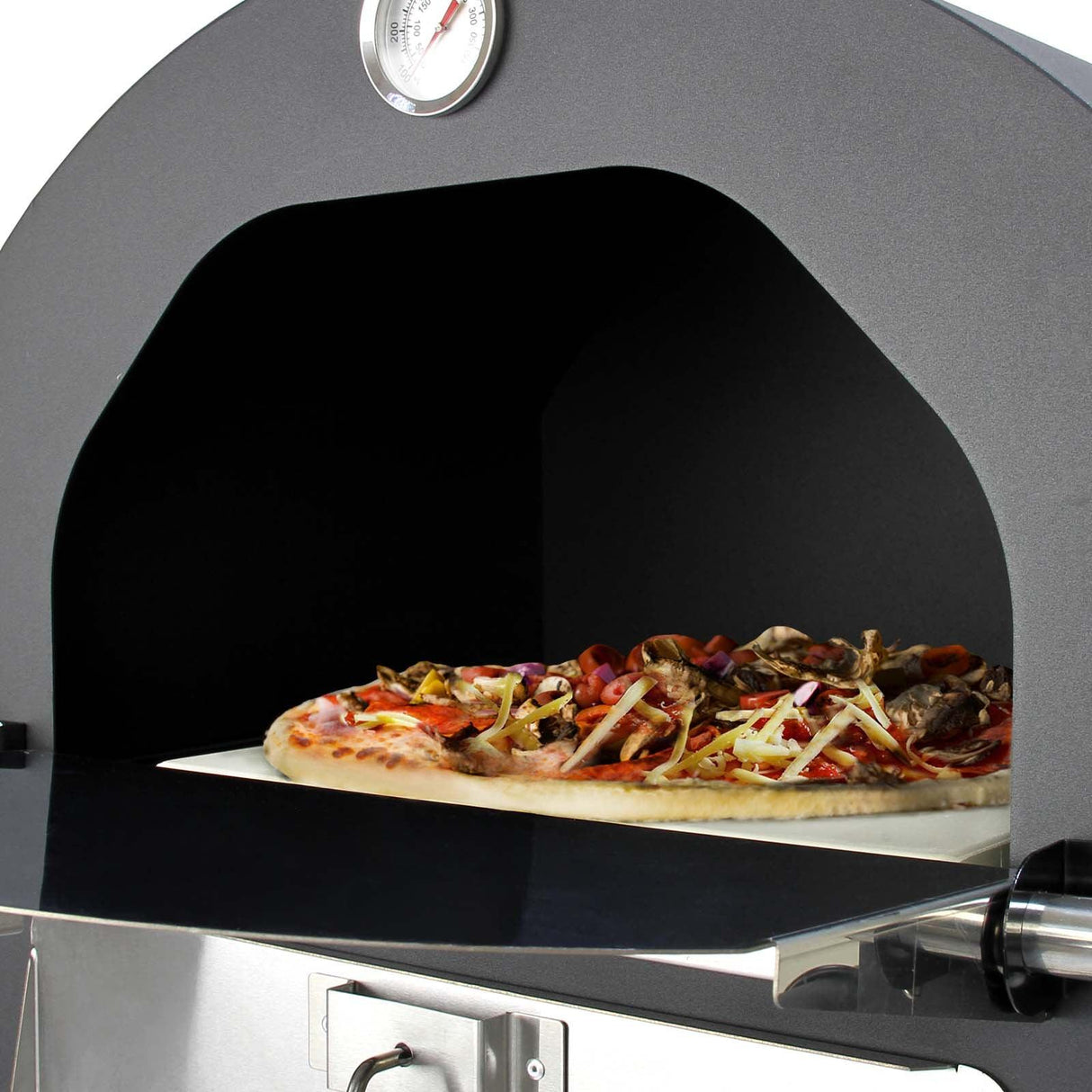 KuKoo outdoor pizza oven with a black finish, featuring a large opening and a pizza peel holding a loaded pizza inside