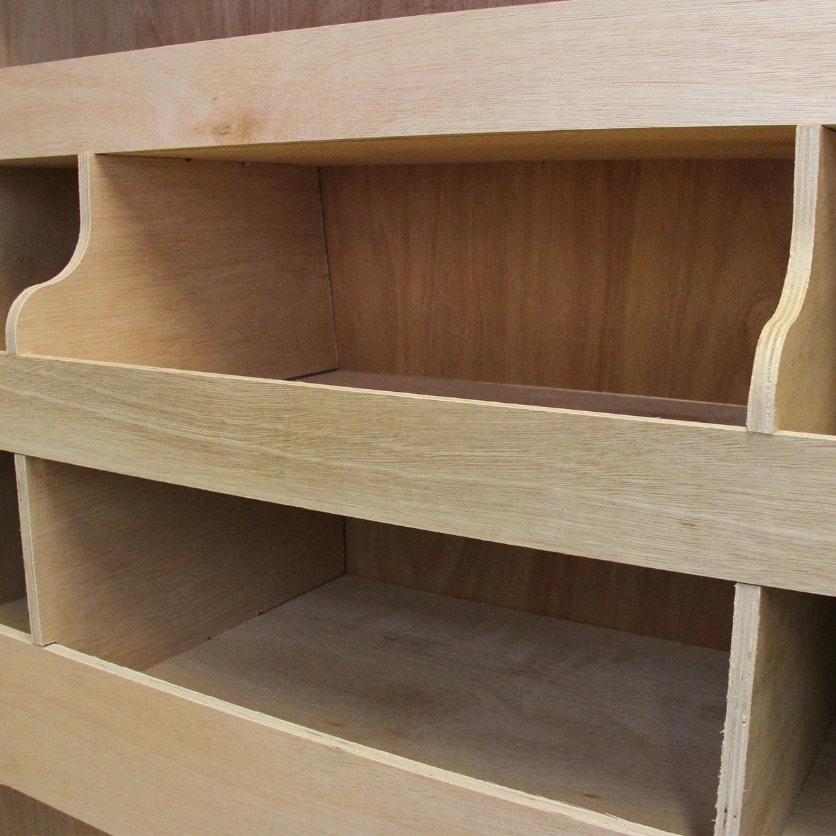 Anthracite van lining with smooth wooden shelves, showcasing spacious compartments for VW Transporter storage solutions
