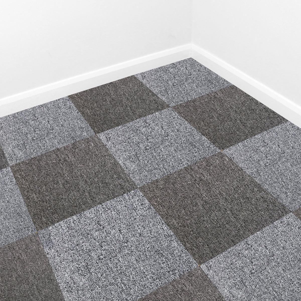 Anthracite carpet tiles arranged in a checkerboard pattern, showcasing a textured surface in shades of gray and charcoal