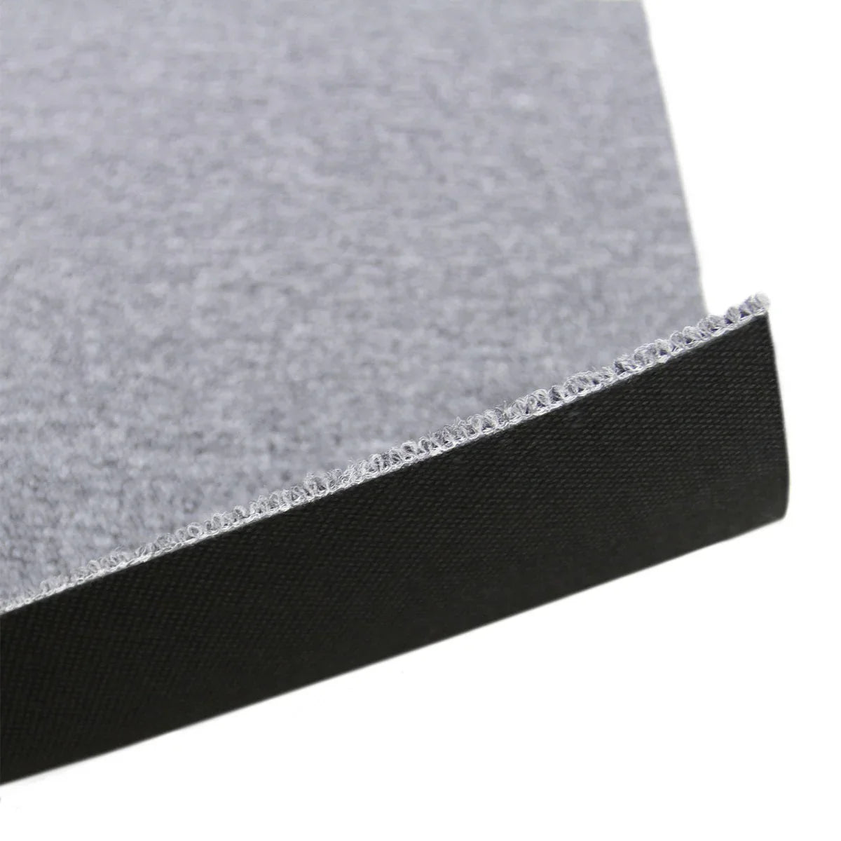 Platinum grey carpet tile with a textured surface and black backing, showing a close-up of the edge for detail and durability