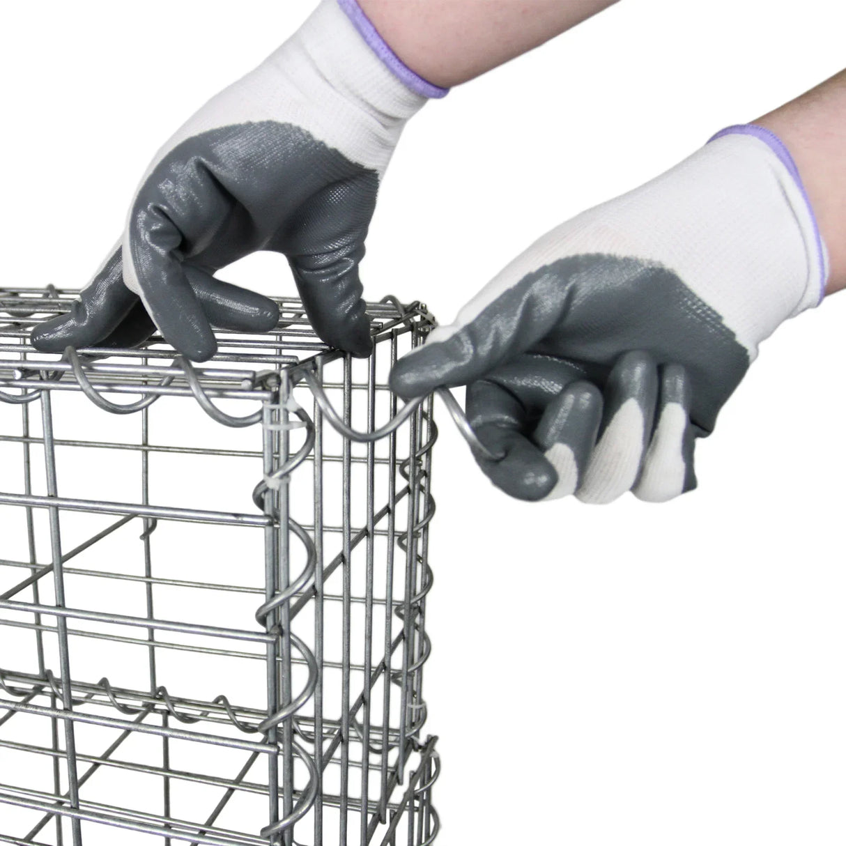 Galvanized steel gabion basket being assembled with gloved hands, showcasing its sturdy wire construction and rectangular shape