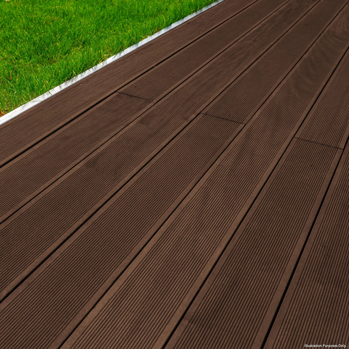 Jardí Composite Decking in Conker Brown, featuring a textured surface and rich brown color, laid on a grassy area for outdoor use