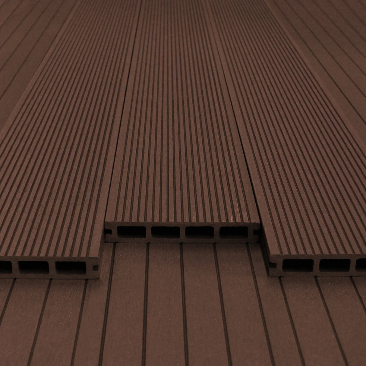 Jardí Composite Decking in Conker Brown, featuring a textured surface with grooves, ideal for outdoor spaces and patios